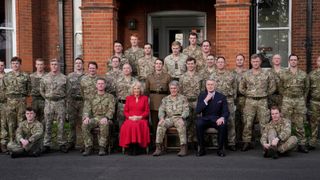 Camilla, Queen Consort and Colonel of the Grenadier Guards, poses for a group photo as she visits Lille Barracks