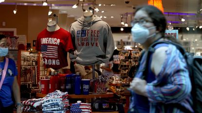 Woman walking in front of a shop in the US