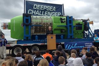 Director James Cameron addresses middle school students and other onlookers in Woods Hole, Mass., at a ceremony in which he donated his submarine, the Deepsea Challenger, to the Woods Hole Oceanographic Institution on June 14, 2013. Cameron piloted the craft to the Challenger Deep, which is 35,787 feet (almost 11,000 meters) beneath the ocean.
