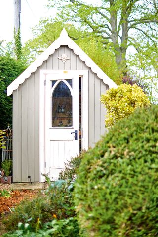 how to paint a shed: pretty grey and white shed with roof detail