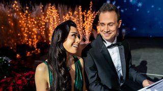 Aimee Garcia and Freddie Prinze Jr sit at a piano for Christmas With You.