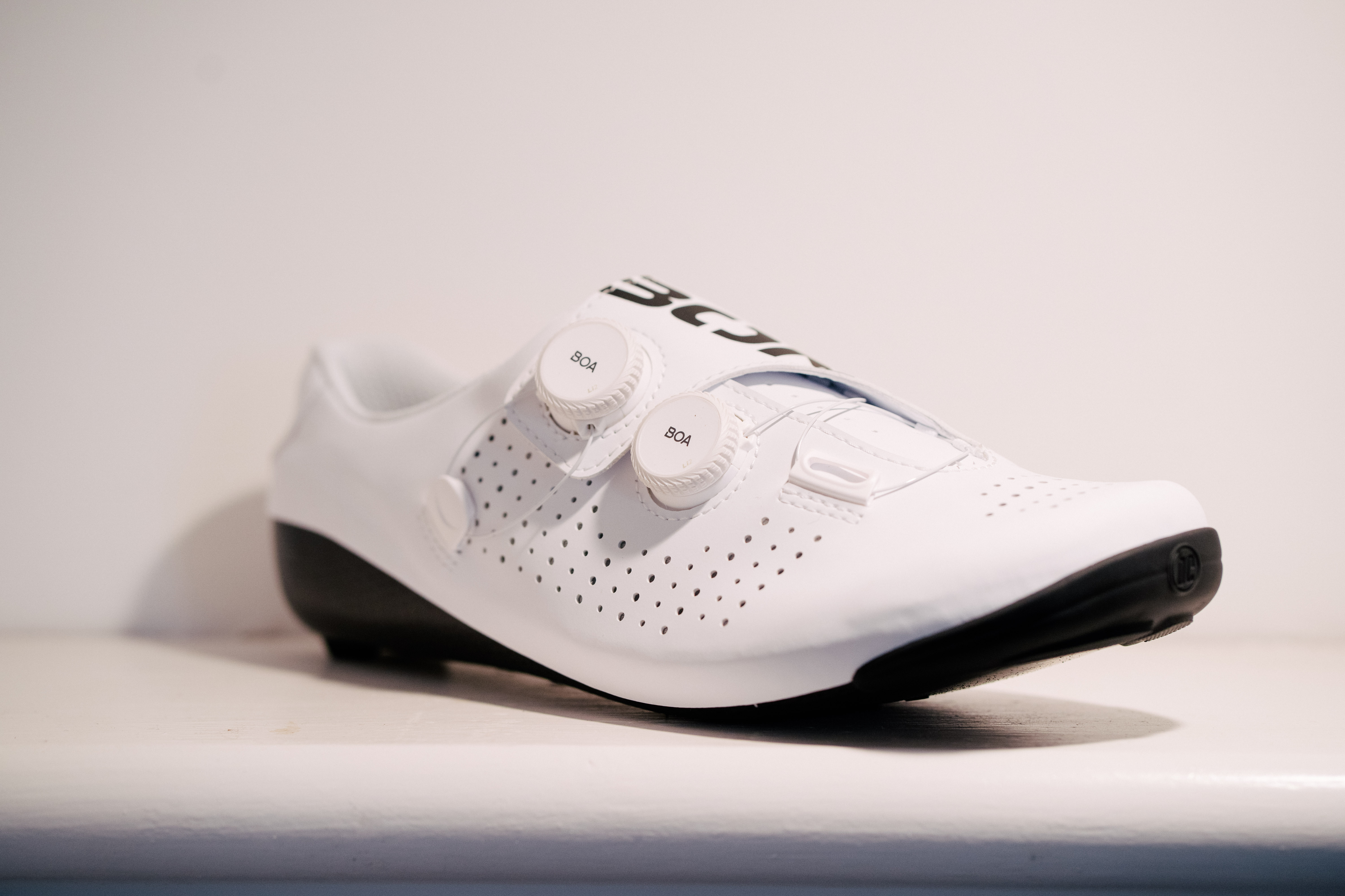 A white bicycle shoe on a shelf