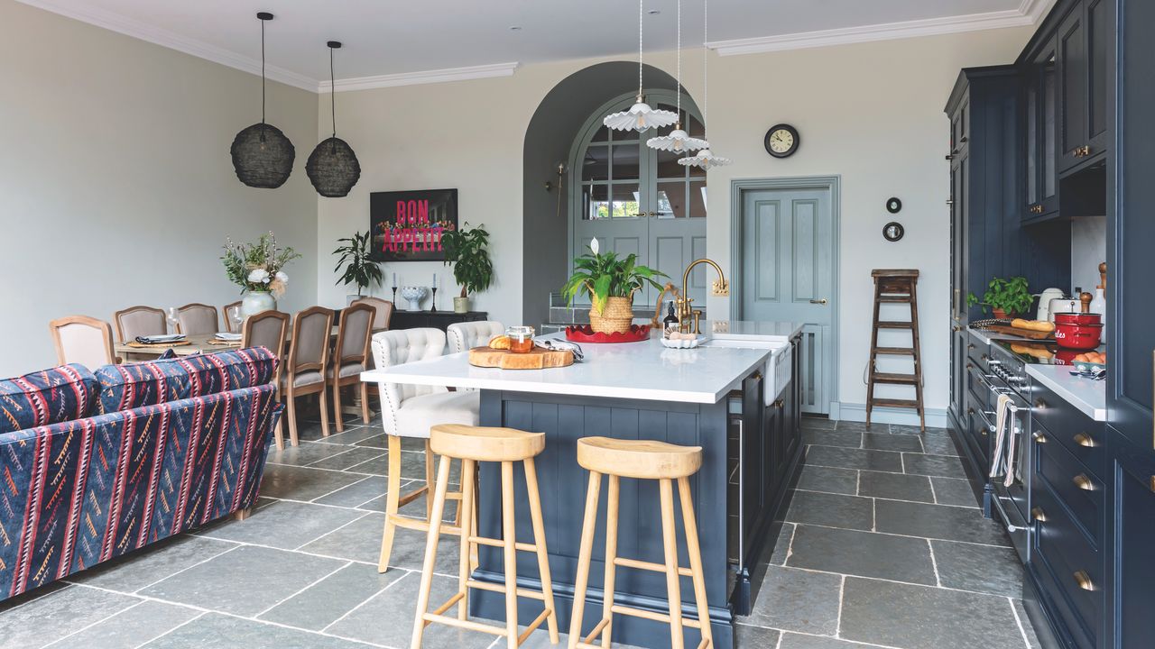 Open plan kitchen living diner with island, pendant lighting and blue cabinetry