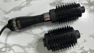 The Hot Tools Volumiser Set 2-in-1 Brush and Dryer with one brush attached and the other to the side of it