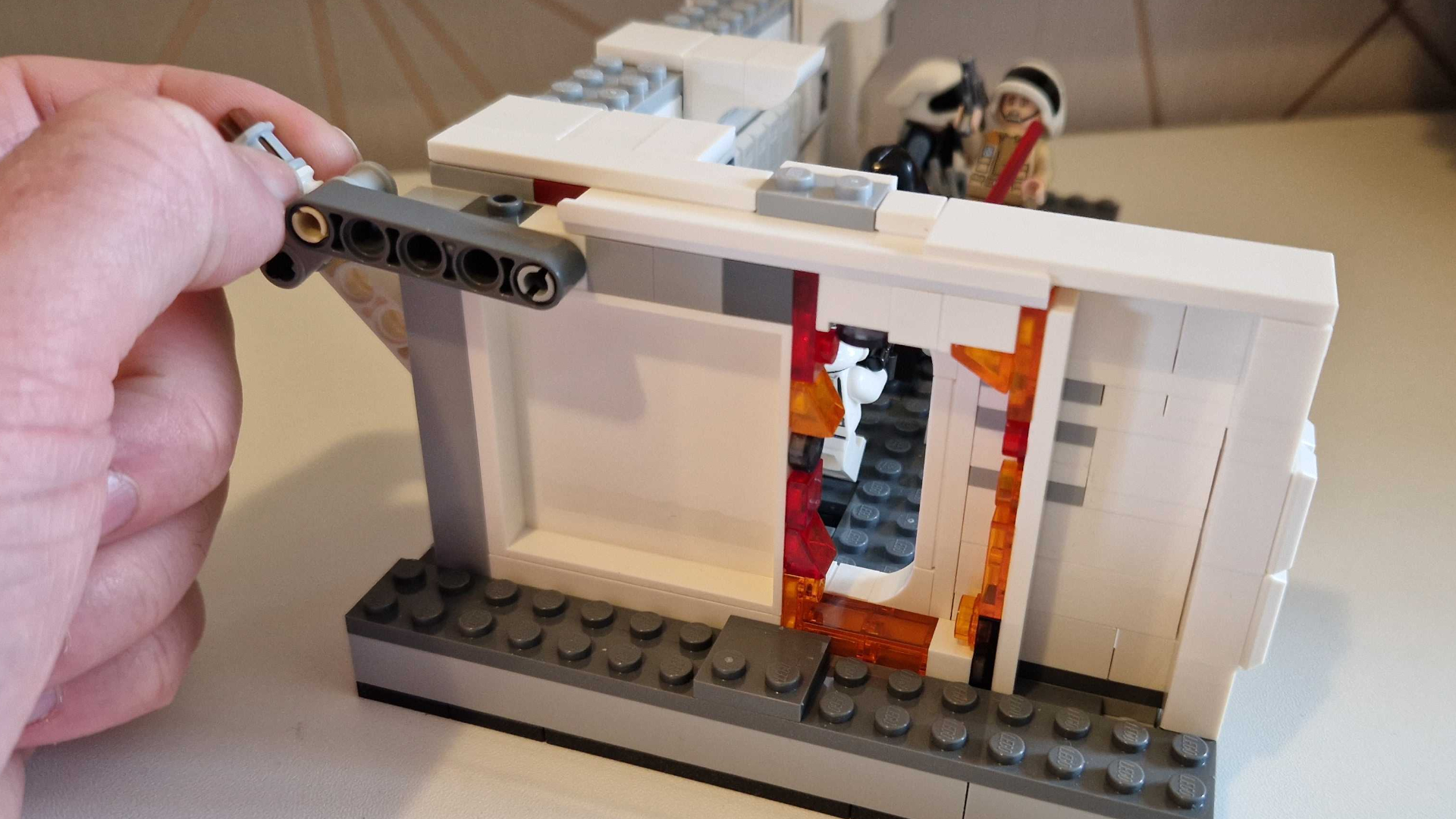 A hand pulls a lever to open the door on Lego Boarding the Tantive IV