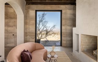 morning dove, a new house at twentynine palms by homestead modern, showing rammed earth walls, rough and contemporary volumes and windows out to desert landscape views