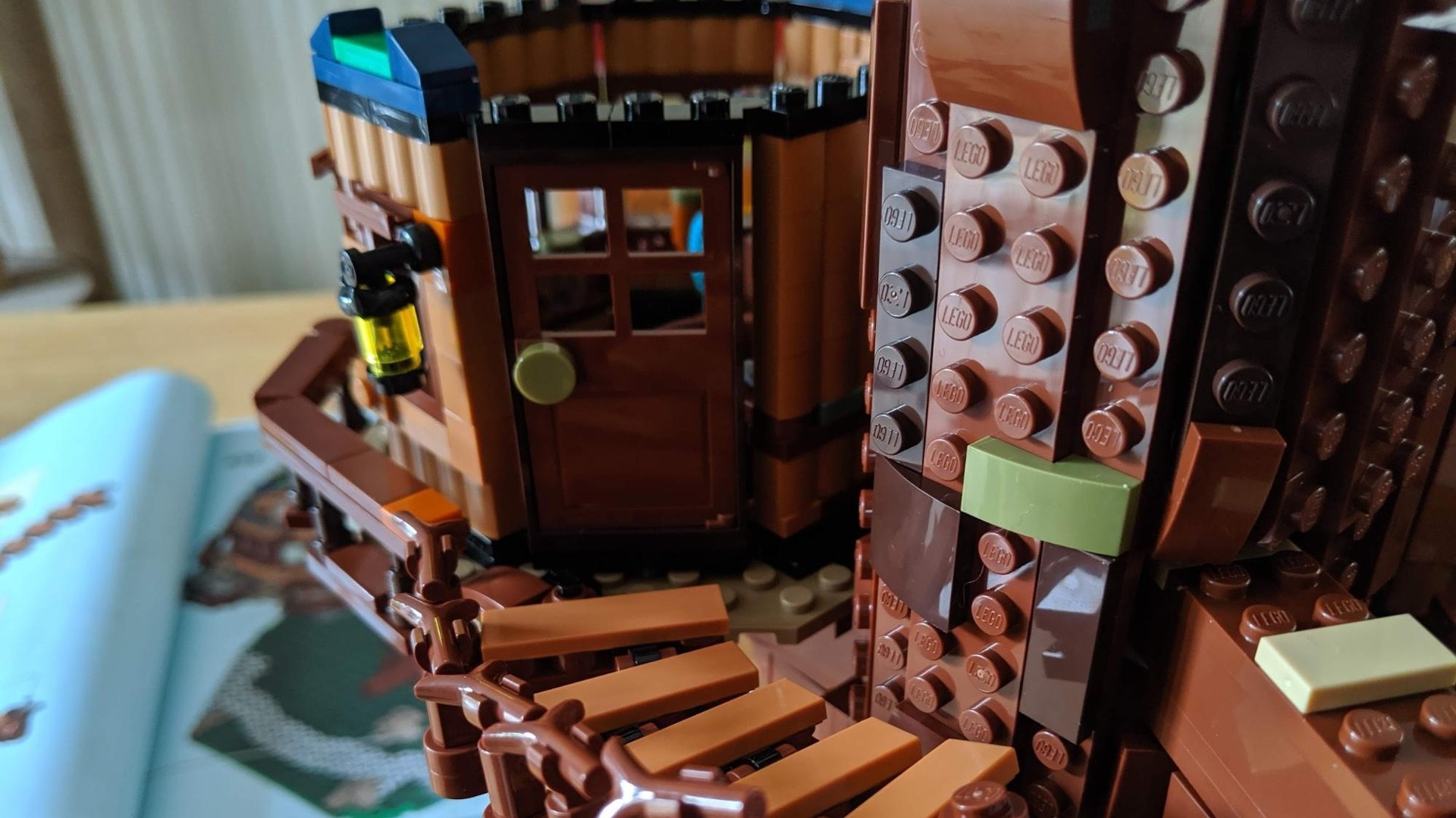 Lego Ideas Tree House 21318 - close up of bridge and door of tree house.
