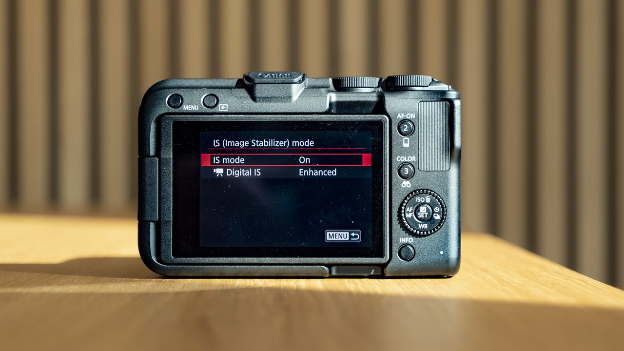 Rear of the Canon EOS R50 V, on a wooden table, screen on