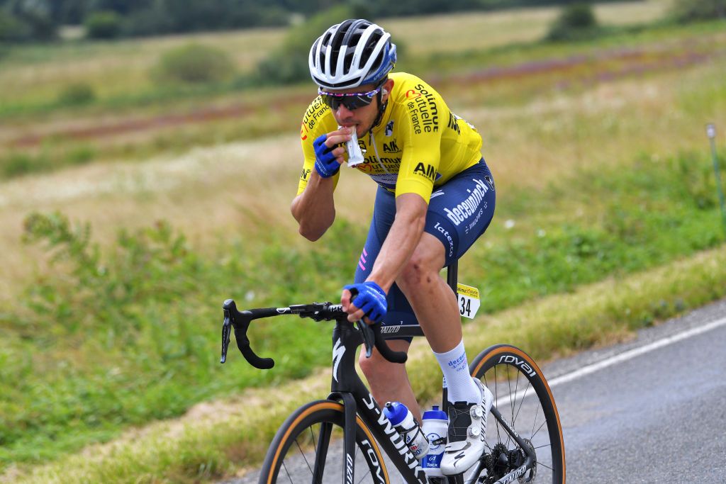 SAINTVULBAS FRANCE JULY 30 lvaro Jos Hodeg Chagui of Colombia and Team Deceuninck QuickStep Yellow Leader Jersey rides whilst eating during the 33rd Tour de lAin 2021 Stage 2 a 136km stage from Lagnieu to SaintVulbas tourdelain on July 30 2021 in SaintVulbas France Photo by Luc ClaessenGetty Images
