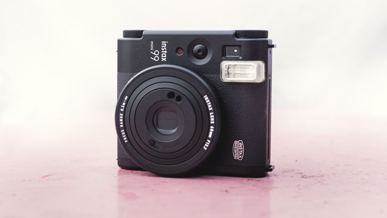 Fujifilm Instax Mini 99 on a marble pink surface