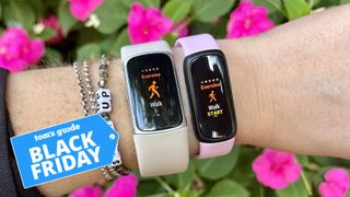 Two Fitbit devices on a person's wrist with the Tom's Guide Black Friday deals badge