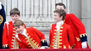 Prince George smiling as he poses for a photo with friends