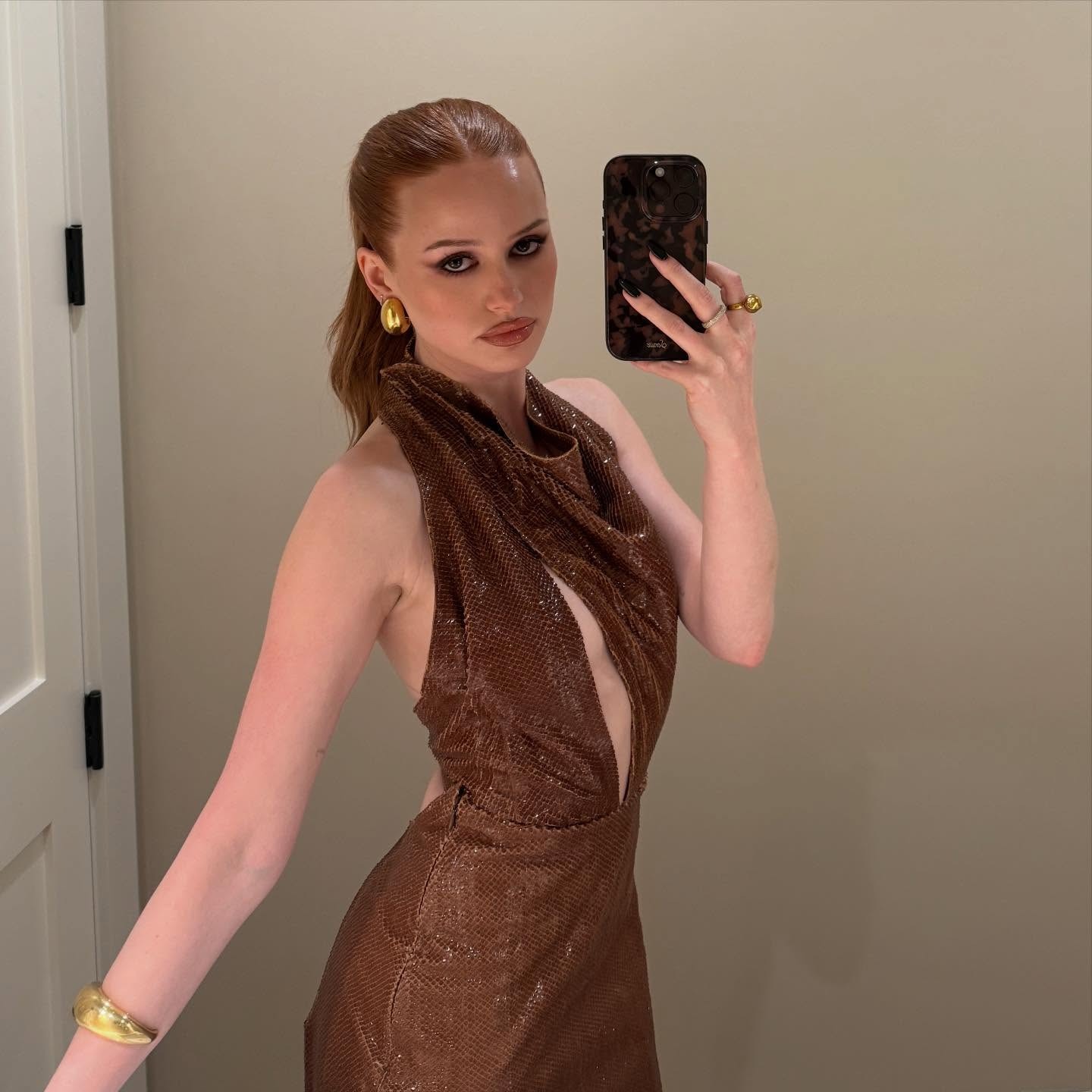 Madelaine Petsch posing for a mirror selfie.