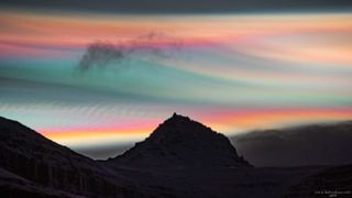 Bright multi-colored clouds shining in the night sky above Mount Jökultindur in Iceland on Jan. 25.