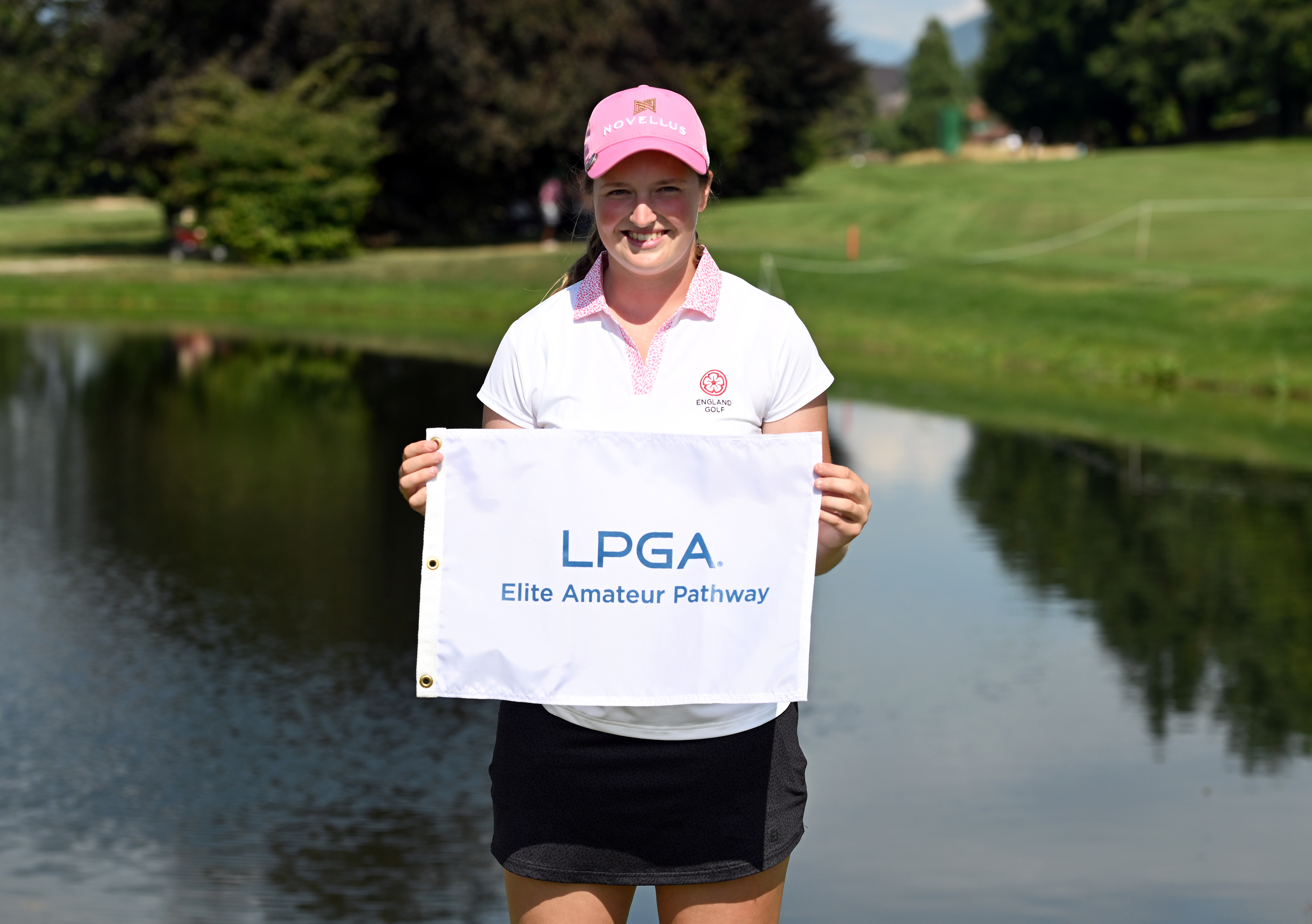 Lottie Woad holds an LPGA Tour flag