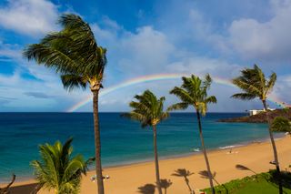 A rainbow appears over Black Rock in Kaanapali Beach in Maui