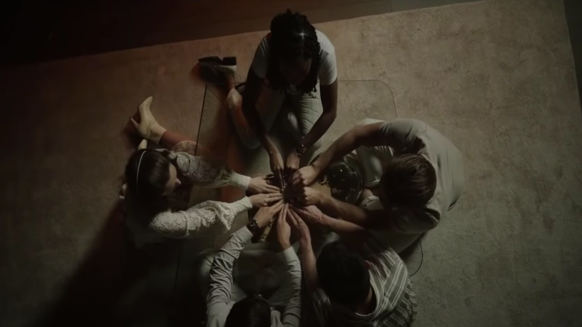 American Horror Stories screencap sees five people circled around calling to spirits
