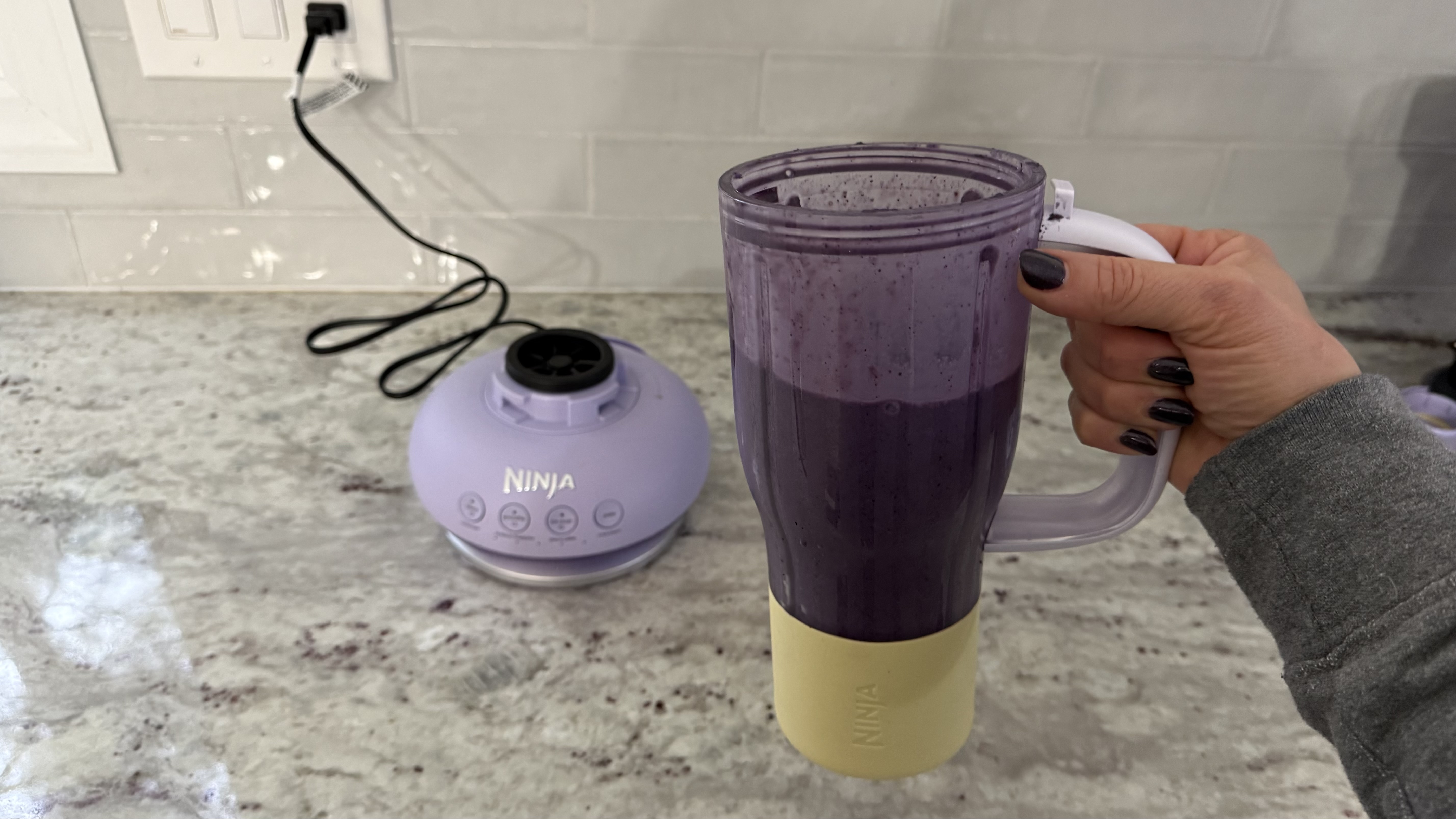 Ninja BlendBOSS&trade; Tumbler Blender with 26oz Travel Tumbler making banana, blueberry, and spinach smoothie
