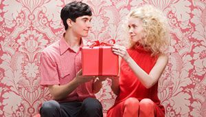 man giving present to woman