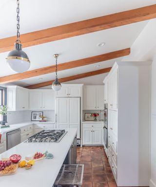 All-white kitchen scheme with exposed wood beams, and plenty of natural daylight
