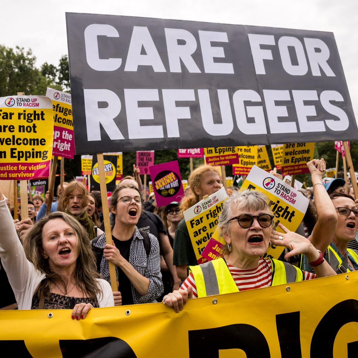 Counter-protesters from Stand Up To Racism march towards the Bell Hotel where a protest is taking place against the use of the hotel as migrant accommodation on July 27, 2025 in Epping, England. 