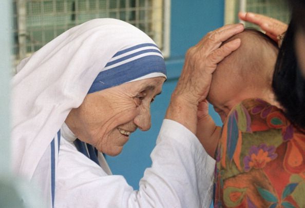 Mother Teresa blesses a child in Singapore.