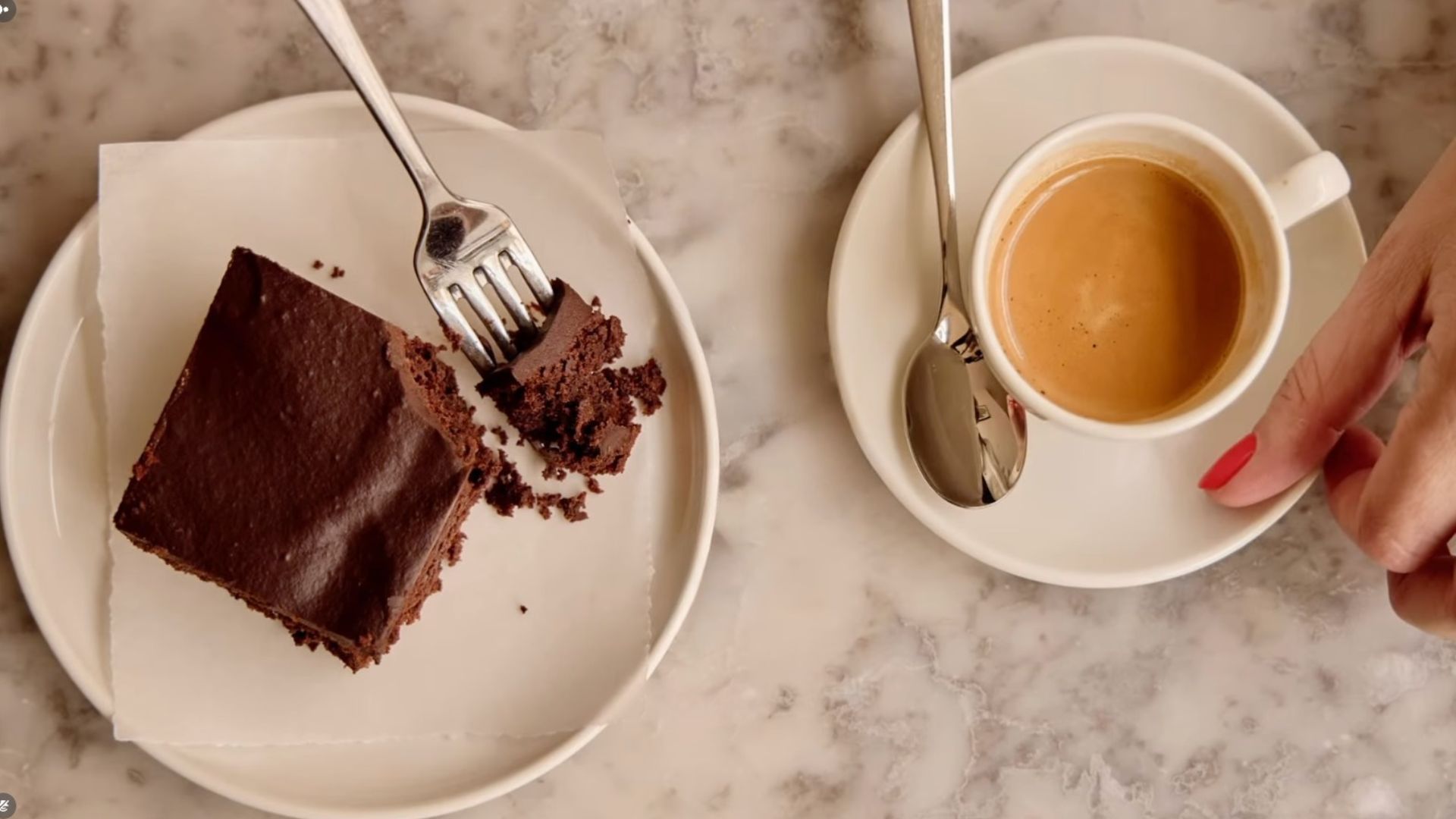 an image of a cup of coffee and cake on a marble table