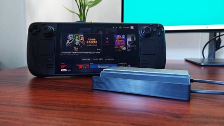 BenQ Steam Deck dock next to handheld on woodgrain desk