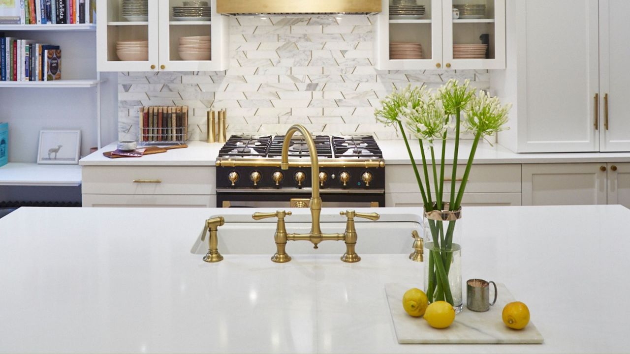 A clean home with a gold featured faucet 