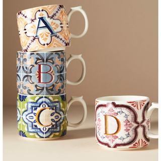 four monogram mugs stacked with colorful mosaic patterns