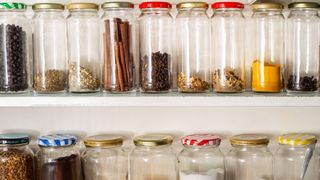 Glass storage jars in kitchen cupboard