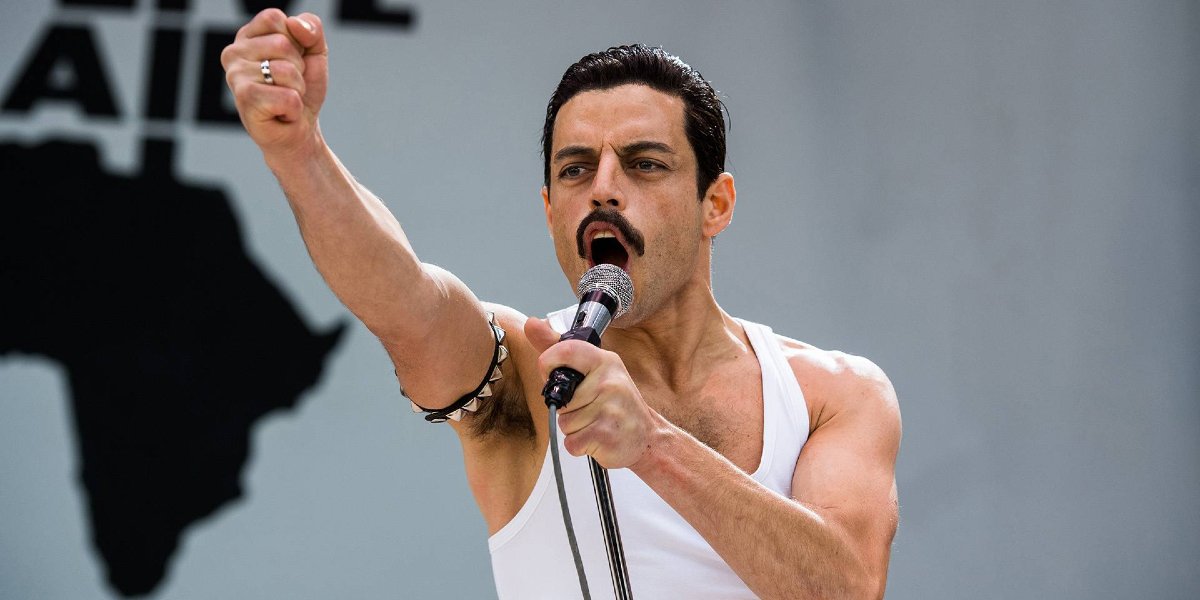 Rami Malek raises his fist during Live Aid in Bohemian Rhapsody.