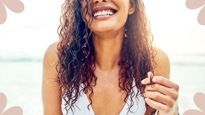 model showing how to use sea salt spray on beach