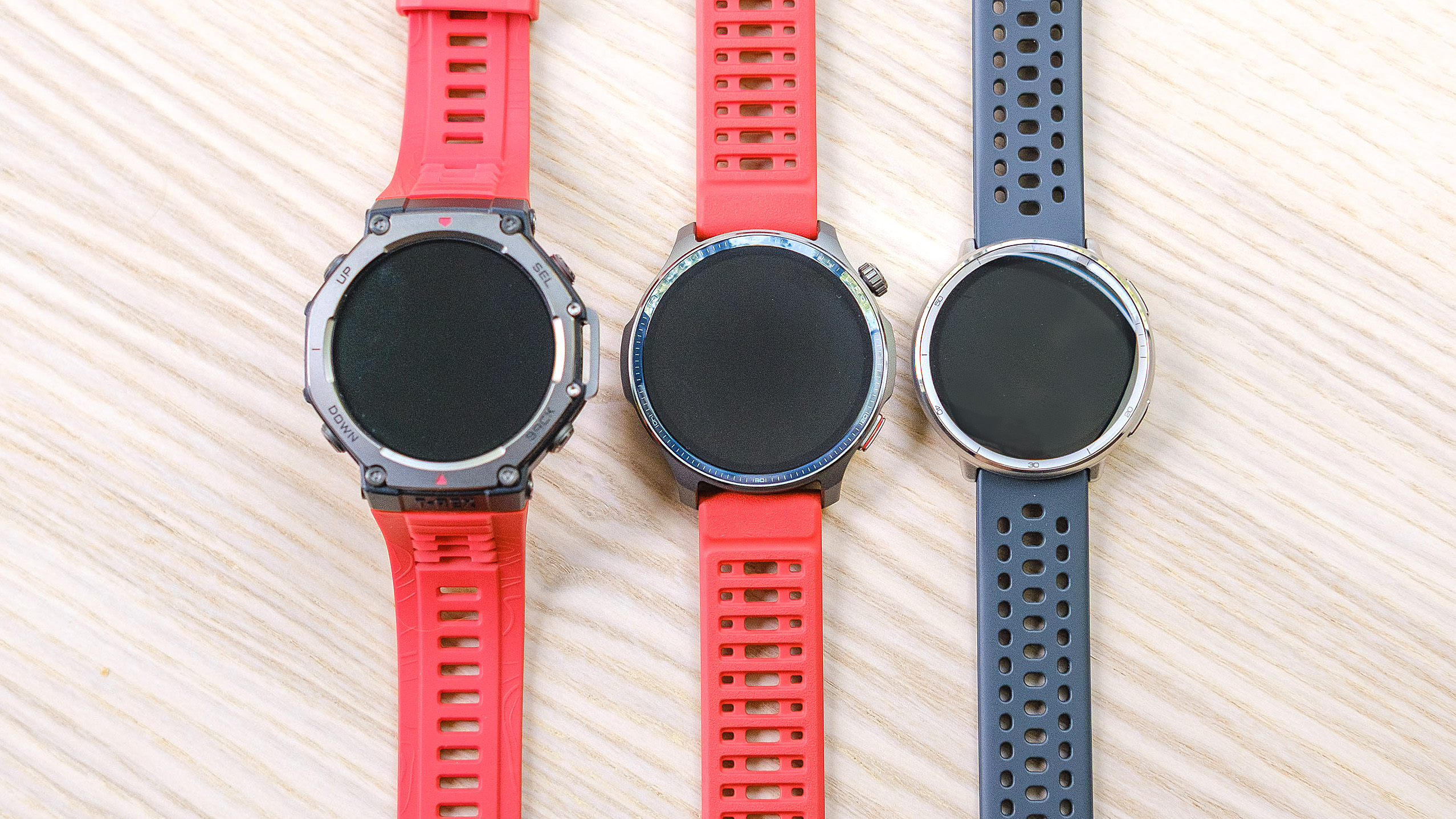 Close-up of the Amazfit Balance 2 smartwatch sitting in between the Amazfit T-Rex 3 (left) and Amazfit Active 2 (right)