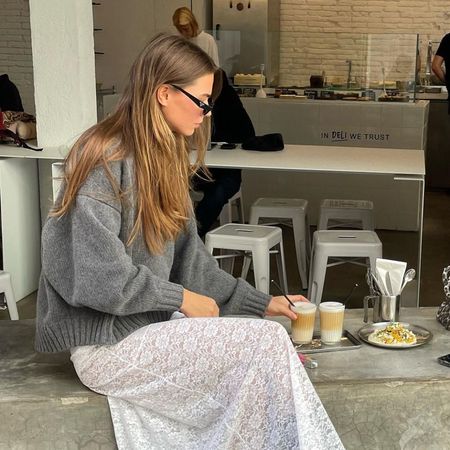 Influencer wears a lace skirt with biker boots.