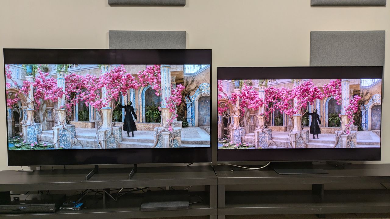 Samsung S85F (left) vs Samsung S95F (right) showing Elphaba from Wicked under a pink tree, both set to Filmmaker Mode