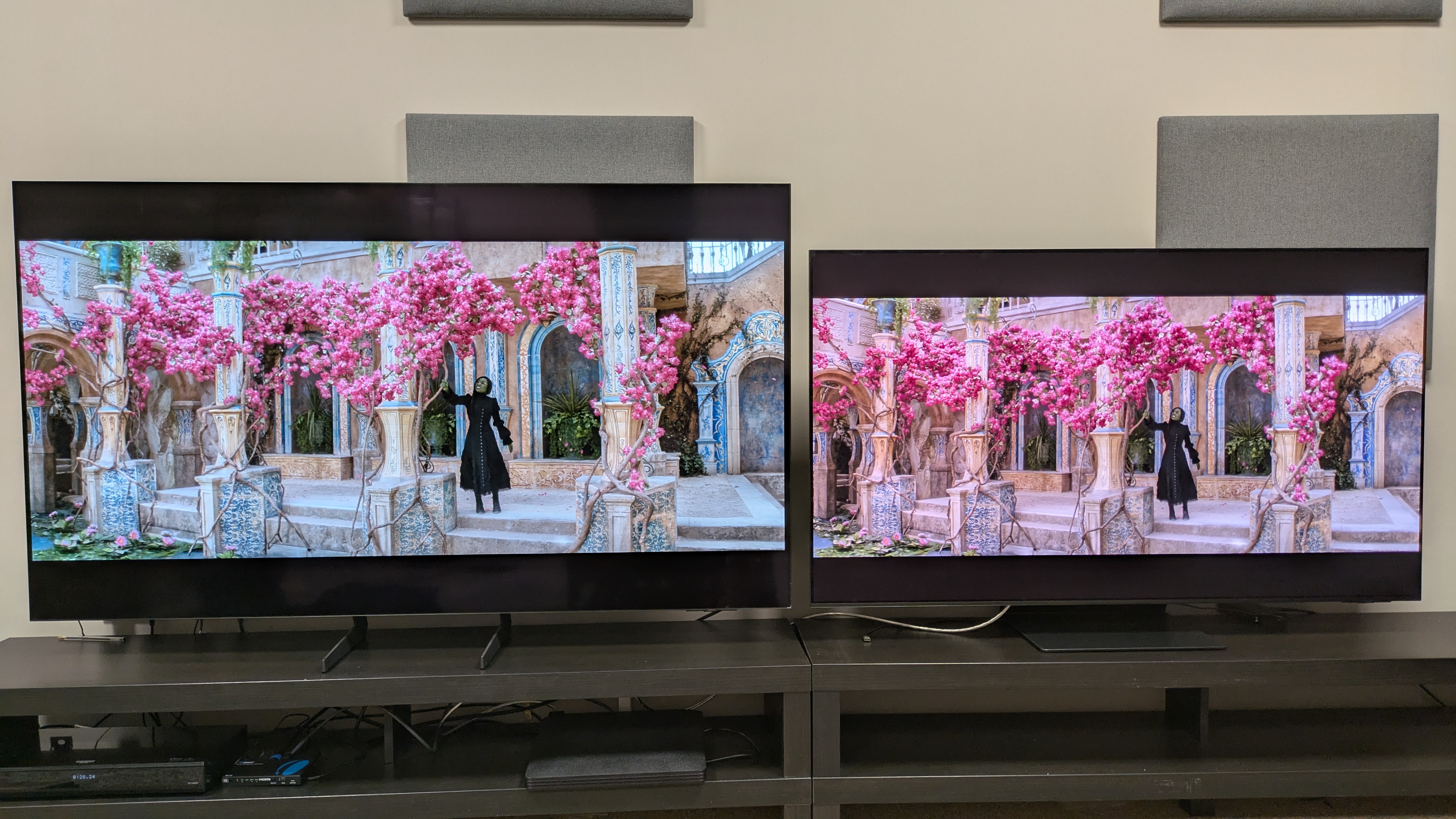 Samsung S85F (left) vs Samsung S95F (right) showing Elphaba from Wicked under a pink tree, both set to Filmmaker Mode