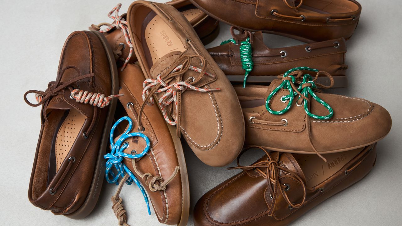 a pile of Aritzia x Sperry boat shoes in front of a plain backdrop