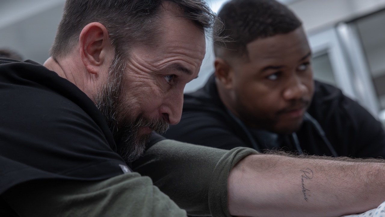 Robby and Dr. Crus holding onto a patient's shoulders for traction in The Pitt Season 2x14