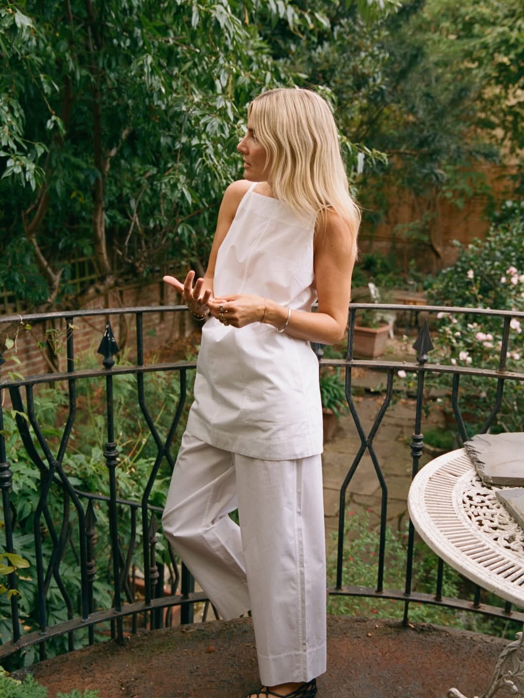 Influencer Lucy Williams wearing a white linen tunic top.