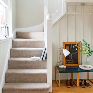 Neutral hallway and staircase with wall panelling