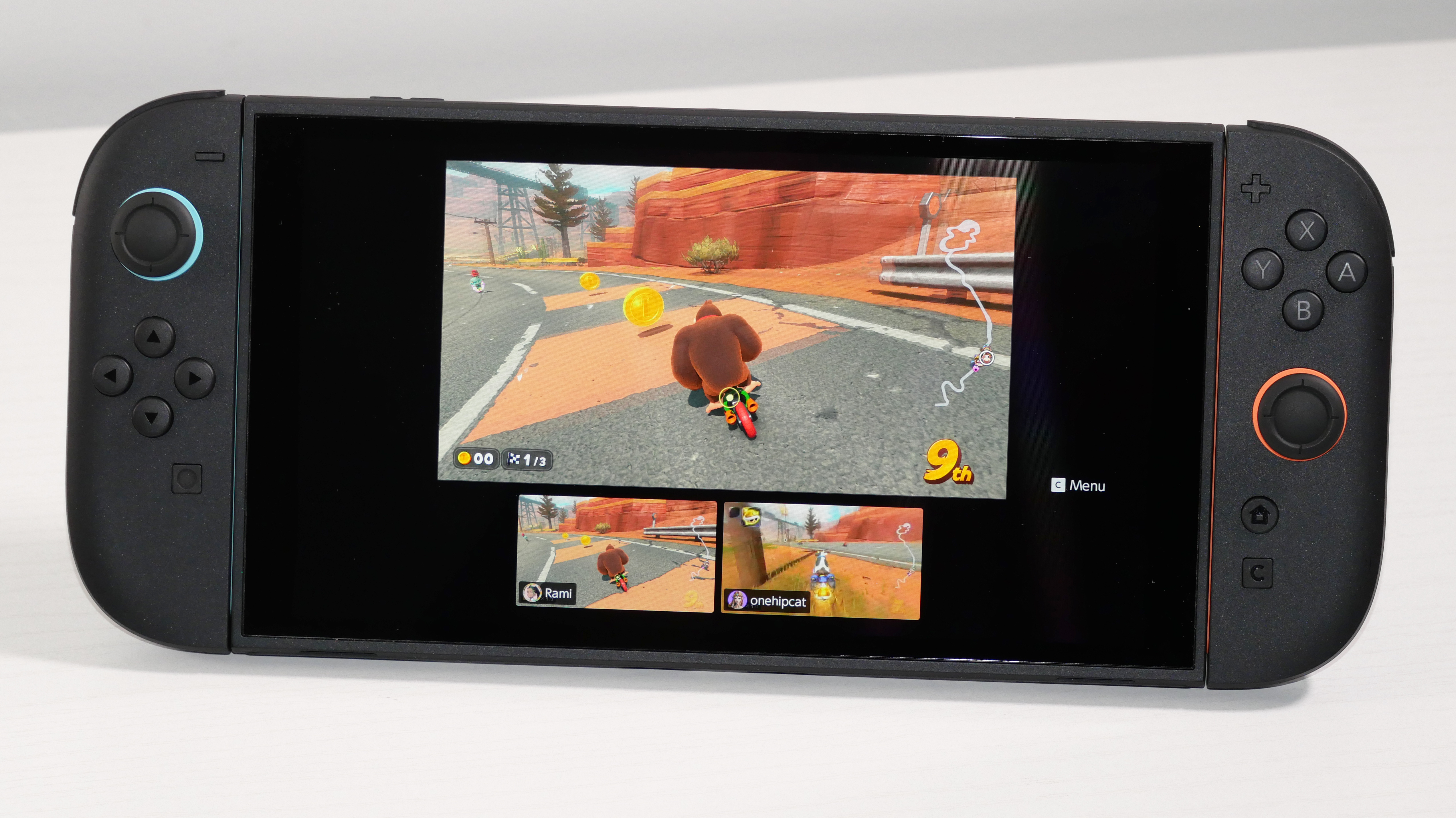 Nintendo Switch 2 laying on a white desk, highlighting GameChat Streaming.