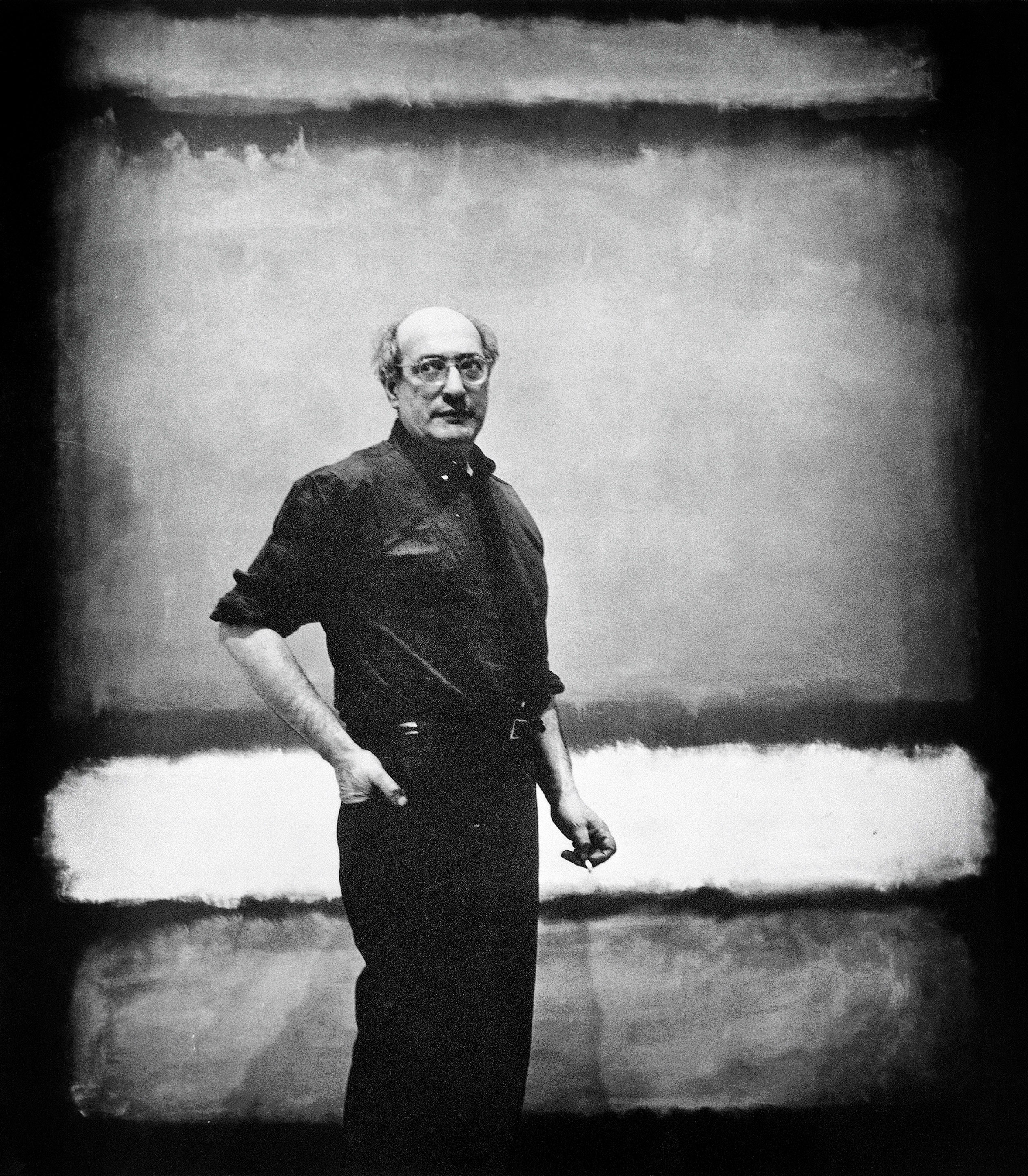 Mark Rothko standing infront of a large canvas