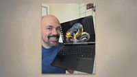 Rhener Furtado proudly holds a 50th Anniversary Surface Laptop featuring an elegant gold design, showcasing its stylish appearance.