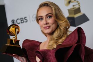 Adele holding a Grammy