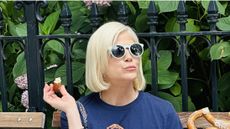 Selma Blair with blonde hair wearing sunglasses