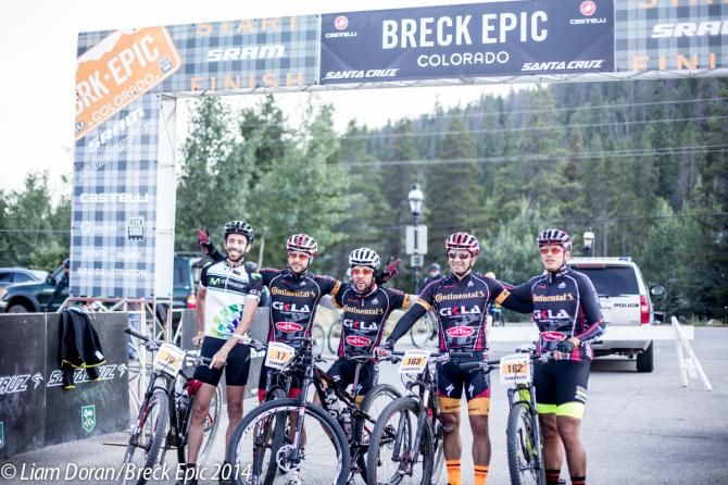 Finishers of day one celebrate under the start banner
