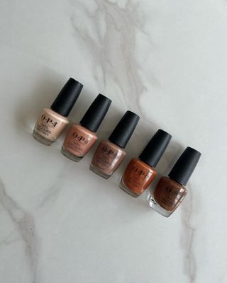 Flatlay of OPI nail polishes, from light beige to brown