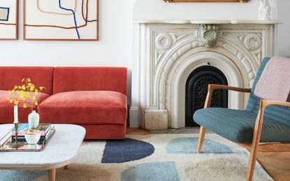 A bright colored living room with a coral velvet sofa