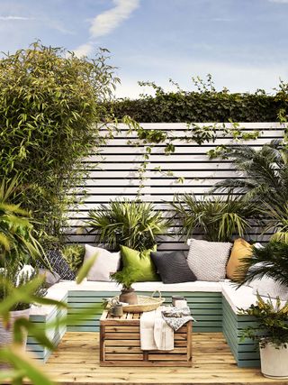 small garden with contemporary fence and coloured decking